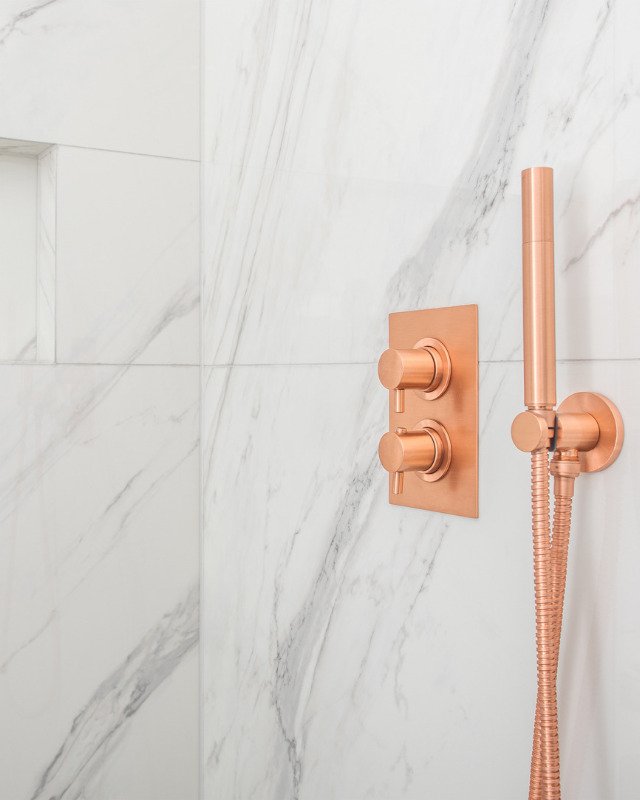 A bath remodel in Arlington, VA showing a shower with Copper Metallic Shower Water Control Valves